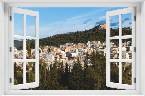 Athens, Attica, beautiful super-wide angle view of Athens, Greece, with Acropolis, Mount Lycabettus, mountains and scenery beyond the city, seen from Strefi Hill park in Exarcheia neighbourhood