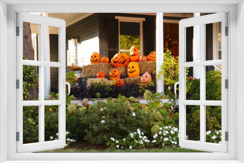 Fototapeta Naklejka Na Ścianę Okno 3D - Jack O'Lanterns Await Trick or Treaters, Outdoor Halloween Decorations With Pumpkins