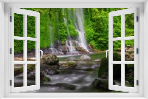 Fototapeta Naklejka Na Ścianę Okno 3D - the view of a waterfall in the beautiful tropical forest
