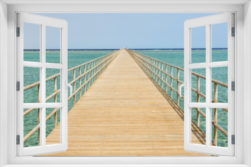 Fototapeta Naklejka Na Ścianę Okno 3D - Very long wooden pier footbridge in ocean sea. High quality photo
