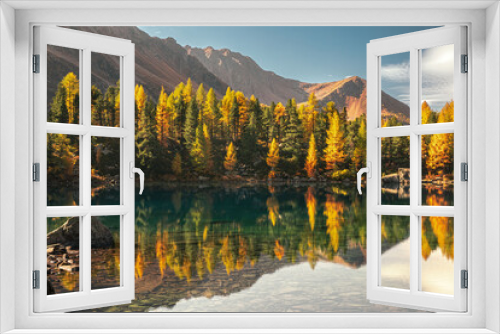 Fototapeta Naklejka Na Ścianę Okno 3D - autumn view of Saoseo lake in the Dolomites. Fantasy autumn scene with colorful sky, majestic rocky mountain and colorful trees glowing with sunlight
