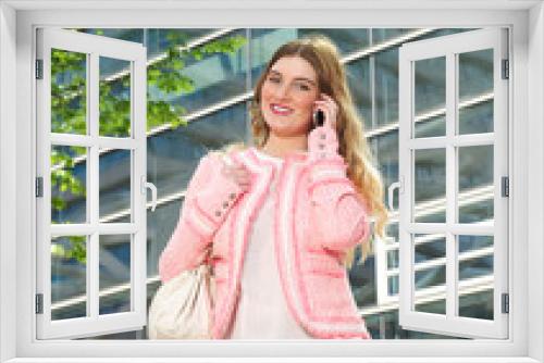 Elegant young lady talking on mobile phone outdoors