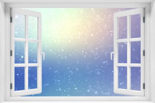 Light snow falling on shiny blue iridescent empty backdrop. Winter airy soft textured background.