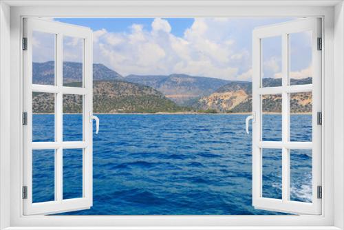 Fototapeta Naklejka Na Ścianę Okno 3D - View of the rocky shore from the sea. Mediterranean Sea in Turkey. Popular tourist places. Background