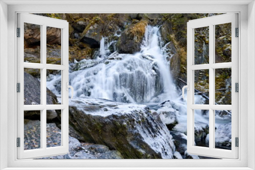Fototapeta Naklejka Na Ścianę Okno 3D - Russia. South of Western Siberia. One of the most beautiful waterfalls of the Altai Mountains on the Karasu River near the village of Chibit on the Chui tract, chained with ice of autumn frosts.