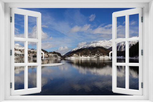 Saint Moritz, Switzerland: Reflection of the Saint Moritz village in the lake on a winter day in Canton Graubunden in the alps in Switzerland