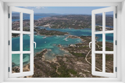Fototapeta Naklejka Na Ścianę Okno 3D - Aerial view of La Maddalena Island, Isola Giardinelli with the drone view of Caprera Island in Sardegna, Italy. Birds eye view of crystalline and turquoise water in north Sardinia, luxury yacht, boat.