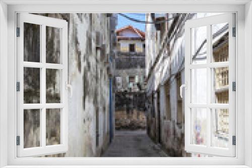 Fototapeta Naklejka Na Ścianę Okno 3D - Narrow streets of the old city. Open windows, balconies, antique doors.
