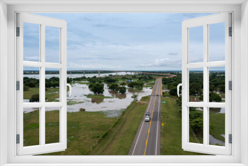 Fototapeta Naklejka Na Ścianę Okno 3D - Flooding around the Bridge of Reconciliation that joins two banks of the Magdalena River in the department of Bolivar. Colombia.