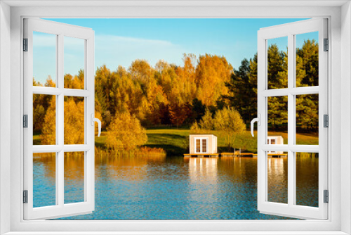 Fototapeta Naklejka Na Ścianę Okno 3D - Fall season landscape with floating grey cabins on the lake