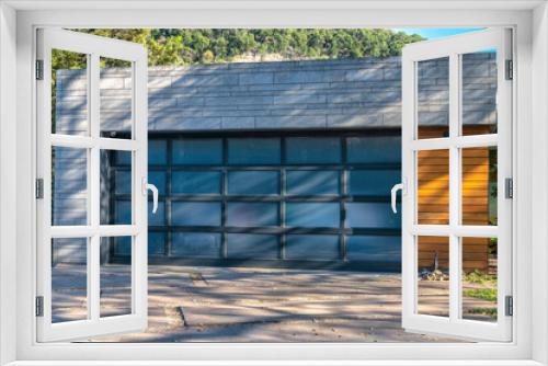 Fototapeta Naklejka Na Ścianę Okno 3D - Modern detached garage exterior with frosted glass panels on garage door- Lake Austin, Austin, Texas