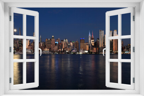 Fototapeta Naklejka Na Ścianę Okno 3D - New York City skyline at night including the moon and nice reflection into Hudson River, USA
