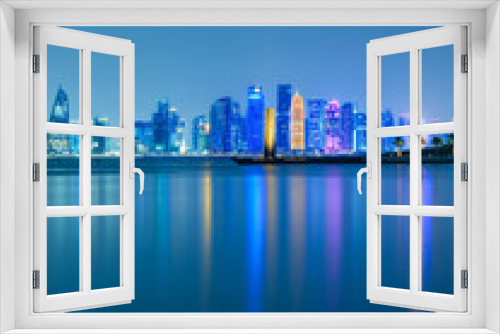 Fototapeta Naklejka Na Ścianę Okno 3D - Vertical long exposure shot of Doha city skylines illuminated at night in Doha, Qatar