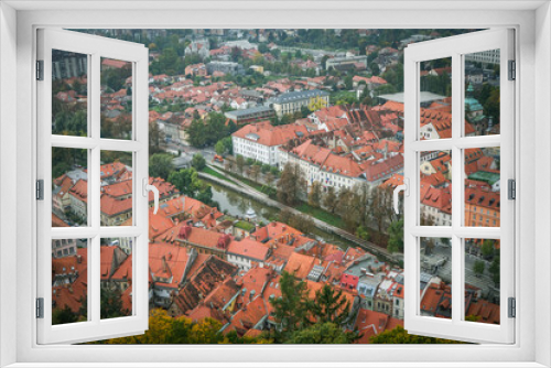 Fototapeta Naklejka Na Ścianę Okno 3D - Looking out over the city, you can see the creek and most of the red roofs. Ljubljana is the capital of Slovenia.
