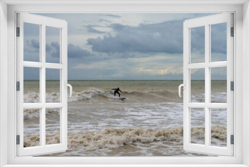 Fototapeta Naklejka Na Ścianę Okno 3D - surfer on a choppy wave in the stormy seas of the English Channel in East Sussex