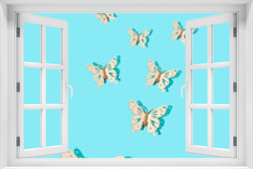 Photo of butterfly pattern isolated on blue background. Minimal concept of love, nature, thanksgiving. Copy space. Flat lay.