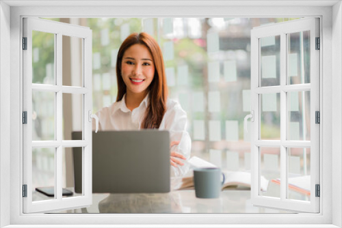 Asian businesswoman working in finance and calculator working with laptop computer with paper documents at office Technology market and financial concepts