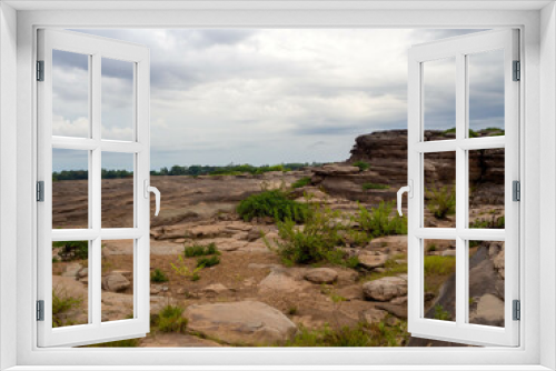 Fototapeta Naklejka Na Ścianę Okno 3D - The rock field or rock shore with the green grass called Han Hong is famous in the middle of the Mekong river during the dry season.