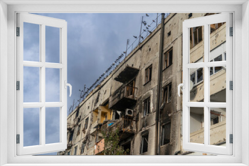 Fototapeta Naklejka Na Ścianę Okno 3D - War in Ukraine. 2022 Russian invasion of Ukraine. An apartment building destroyed by shelling. Destruction of infrastructure. Terror of the civilian population. War crimes