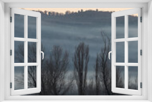 Fototapeta Naklejka Na Ścianę Okno 3D - Mist and fog between valley and layers of mountains and hills with bare trees in the foreground
