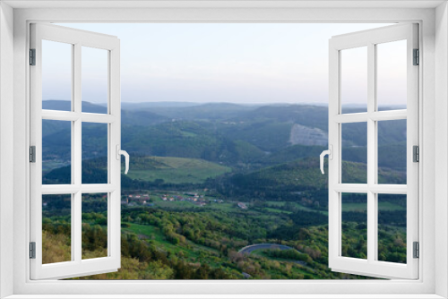 Fototapeta Naklejka Na Ścianę Okno 3D - Scenic view to beautiful green hills and big bridge against red orange sky in spring from Črni Kal, Slovenia