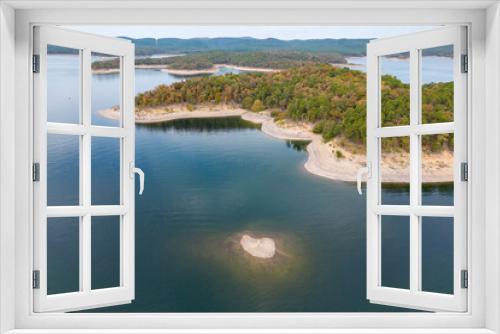 Fototapeta Naklejka Na Ścianę Okno 3D - Aerial view of landscape of water of Broken Bow lake and islands with forest on the bank, Oklahoma, USA. Autumn scenery of coastal line.