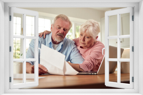 Worried Retired Senior Couple Looking At Bills At Home Concerned About Cost Of Living