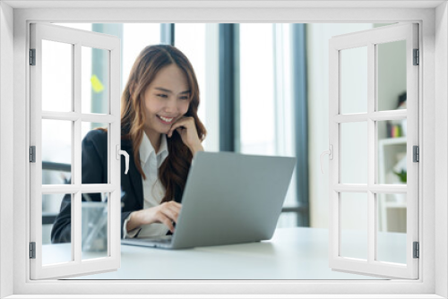 Businesswoman showing joy at her desk successful