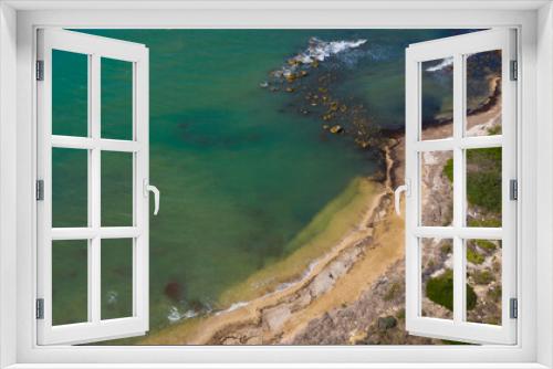 Fototapeta Naklejka Na Ścianę Okno 3D - Aerial view of the Sicilian coast overlooking the Mediterranean sea, in Italy. The sea is turquoise and the beach is sandy. There is no one in the water or on the coast.