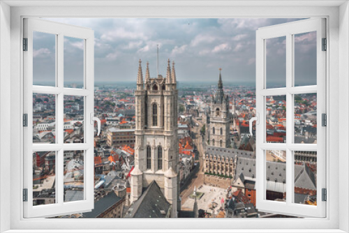 Aerial summer cityscape of the Old Town in Ghent (Gent), Belgium. Sint-Baafskathedraal cathedral and Het Belfort van Gent tower in the foreground