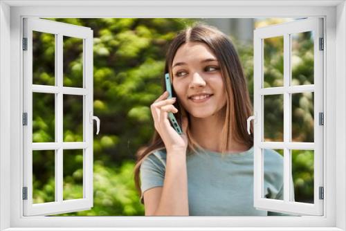 Adorable girl smiling confident talking on the smartphone at park