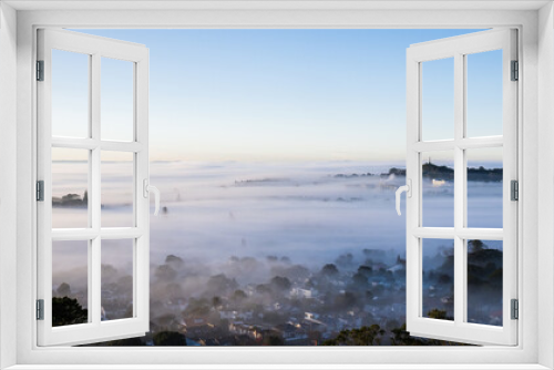 Fototapeta Naklejka Na Ścianę Okno 3D - Auckland city and One Tree Hill in a sea of fog, view from Mt Eden summit.