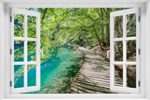 Fototapeta Naklejka Na Ścianę Okno 3D - Wooden bridge footpath over a small lake with bulrush in The Plitvice Lakes National Park in Croatia Europe.