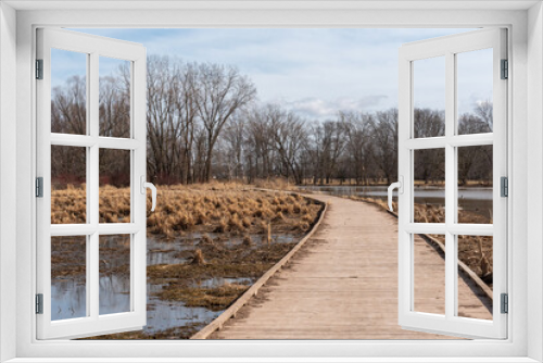 Fototapeta Naklejka Na Ścianę Okno 3D - Wooden Walkway Through The Marsh In Spring