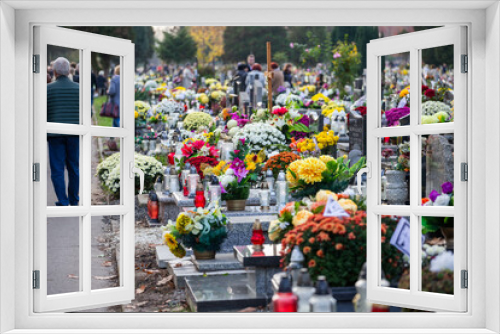 Fototapeta Naklejka Na Ścianę Okno 3D - Groby na cmentarzu ze zniczami i kwiatami