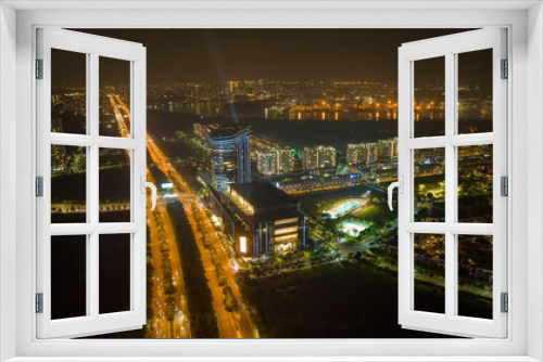 Fototapeta Naklejka Na Ścianę Okno 3D - Aerial night view of Bitexco Tower, buildings, roads, Thu Thiem 2 bridge and Saigon river in Ho Chi Minh city - Far away is Landmark 81 skyscraper. Business and landscape concept.