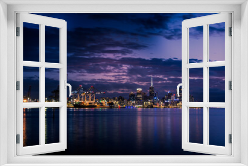 Fototapeta Naklejka Na Ścianę Okno 3D - Bright lights of Auckland downtown at night. Dramatic view over Auckland City from North Shore