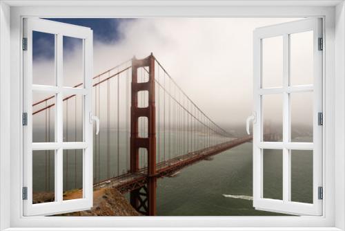 Fototapeta Naklejka Na Ścianę Okno 3D - Golden Gate Bridge partially hidden in fog, San Francisco, California, USA.