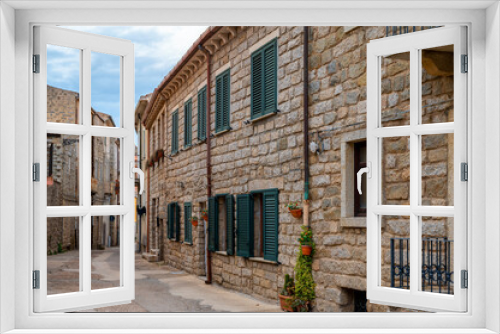 Fototapeta Naklejka Na Ścianę Okno 3D - Schöne Straße mit Häusern mit einer Fassade aus natursteinen in Tempio Pausania im Norden von Sardinien