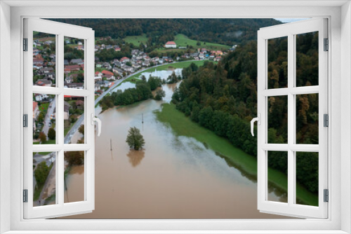 Fototapeta Naklejka Na Ścianę Okno 3D - Extensive deluge across Europe, flooded mountain valley, near the households area and traffic ways, drone shot. Extreme climate event.