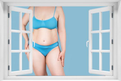 Fat woman in underwear on blue background, overweight female body with copy space