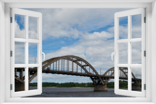 Fototapeta Naklejka Na Ścianę Okno 3D - City bridge across the river with metal arches