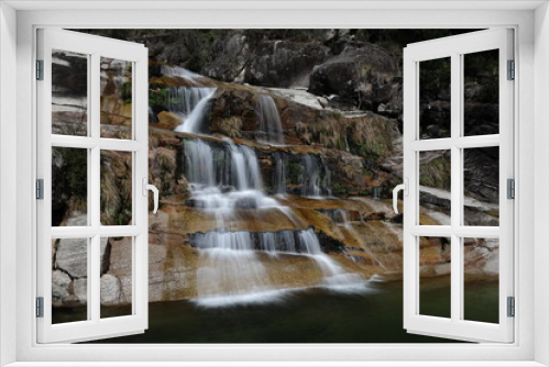Fototapeta Naklejka Na Ścianę Okno 3D - A view of the Cascata Fecha de Barjas waterfalls in the Peneda-Geres National Park in Portugal