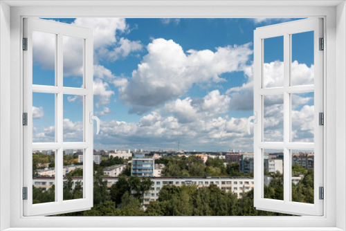 Fototapeta Naklejka Na Ścianę Okno 3D - Bright beautiful white clouds against the midday blue sky over the city.