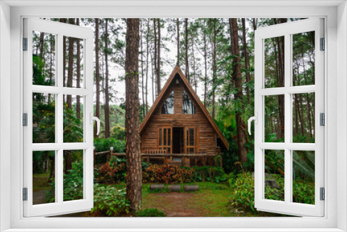 Fototapeta Naklejka Na Ścianę Okno 3D - Triangle house made of wood in the forest in the rainy season