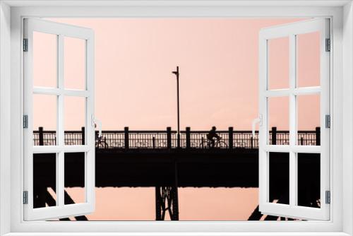Fototapeta Naklejka Na Ścianę Okno 3D - silhouette of a bridge and people