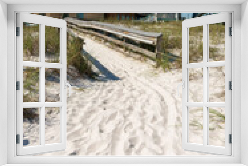 Fototapeta Naklejka Na Ścianę Okno 3D - Path on sand heading to a boardwalk in the middle of sand dunes at the front of hotel- Destin, FL