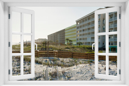 Fototapeta Naklejka Na Ścianę Okno 3D - Hotel buildings with wood pathways on a white sand dunes outdoors in Destin, Florida