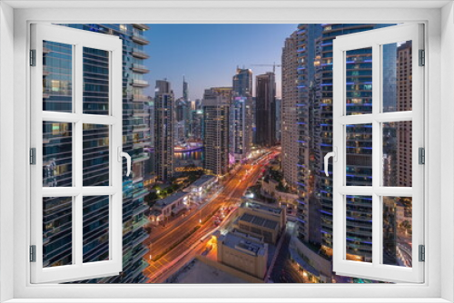 Panoramic view of the Dubai Marina and JBR area and the famous Ferris Wheel aerial day to night timelapse