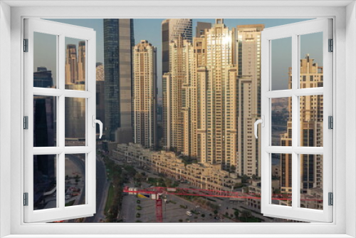 Fototapeta Naklejka Na Ścianę Okno 3D - Bay Avenue during sunrise with modern towers in Business Bay aerial timelapse, Dubai